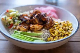 Blackened shrimp rice bowl with avocado, charred corn and pineapple salsa