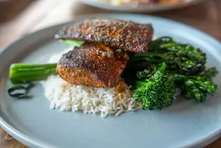 Blackened fish over rice with charred broccolini
