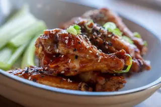 Glazed wings with sesame seeds, scallions and celery