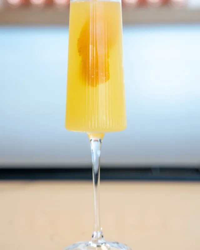 Sparkling citrus cocktail in a fluted champagne glass with an orange slice